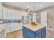 Modern kitchen with white cabinets, stainless steel appliances, and blue backsplash at 21266 S 213Th Pl, Queen Creek, AZ 85142