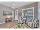 Cozy living room with hardwood floors, striped armchairs, and updated lighting fixtures at 21266 S 213Th Pl, Queen Creek, AZ 85142