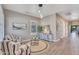 Bright living room featuring striped chairs, a round rug, and modern furnishings at 21266 S 213Th Pl, Queen Creek, AZ 85142