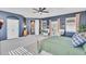 Spacious main bedroom with dark neutral walls, a ceiling fan, and warm natural lighting at 21266 S 213Th Pl, Queen Creek, AZ 85142