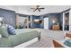 Stylish main bedroom featuring a TV, ceiling fan, neutral walls, and desk area at 21266 S 213Th Pl, Queen Creek, AZ 85142