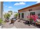 Relaxing backyard patio featuring decorative gravel, lounge chairs, and colorful blooming plants at 21266 S 213Th Pl, Queen Creek, AZ 85142