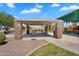 Covered picnic area with stone pillars, seating, and a grill, located near the playground at 21266 S 213Th Pl, Queen Creek, AZ 85142
