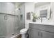 Modern bathroom with walk-in shower, gray vanity and stylish fixtures at 2156 E Cairo Dr, Tempe, AZ 85282