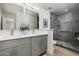 Stylish bathroom features double sinks, gray cabinets, quartz counters, and a glass enclosed tiled shower at 2156 E Cairo Dr, Tempe, AZ 85282