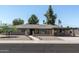 Charming single-story home featuring a brick facade, covered parking, and low-maintenance landscaping at 2156 E Cairo Dr, Tempe, AZ 85282