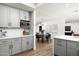 Contemporary kitchen with gray cabinets, quartz countertops, stainless microwave, and open view to dining room at 2156 E Cairo Dr, Tempe, AZ 85282