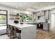 Stylish kitchen with quartz countertops, bar seating, and modern appliances at 2156 E Cairo Dr, Tempe, AZ 85282