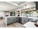 Modern kitchen featuring gray cabinetry, white countertops, stainless steel appliances, and lots of natural light at 2156 E Cairo Dr, Tempe, AZ 85282