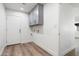 Laundry room includes a wall of cabinets and an exterior door at 2156 E Cairo Dr, Tempe, AZ 85282
