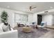 Cozy living room with plantation shutters, light wood floors, and a comfortable seating arrangement at 2156 E Cairo Dr, Tempe, AZ 85282