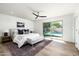 Bright main bedroom with a ceiling fan, ensuite bathroom and sliding doors to the pool area at 2156 E Cairo Dr, Tempe, AZ 85282