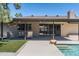Covered patio with outdoor seating overlooking the sparkling backyard pool at 2156 E Cairo Dr, Tempe, AZ 85282