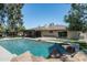 Inviting pool area with rock features and covered patio of the home's exterior at 2156 E Cairo Dr, Tempe, AZ 85282