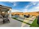 Backyard with a covered patio, pool, and seating area at 23503 S 228Th Pl, Queen Creek, AZ 85142