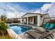 Inviting backyard features a sparkling pool, lounge chairs, patio area, and verdant landscaping at 23503 S 228Th Pl, Queen Creek, AZ 85142
