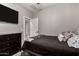 This inviting bedroom includes a bed, dark wood dresser, and an open doorway at 23503 S 228Th Pl, Queen Creek, AZ 85142