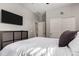 This bedroom offers a comfortable space with a large bed, mounted tv, and a window at 23503 S 228Th Pl, Queen Creek, AZ 85142