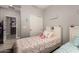 Well-lit bedroom with twin beds, built-in shelves, and an open doorway offering a comfortable and welcoming space at 23503 S 228Th Pl, Queen Creek, AZ 85142