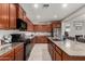 Kitchen showcases granite countertops, wood cabinets, stainless appliances, and functional island with bar stool seating at 23503 S 228Th Pl, Queen Creek, AZ 85142