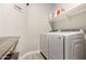 Laundry room with white appliances and shelving at 23503 S 228Th Pl, Queen Creek, AZ 85142