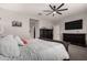 Primary bedroom with carpet flooring, a ceiling fan, ample closet space, and a dark-wood bed frame with white bedding at 23503 S 228Th Pl, Queen Creek, AZ 85142