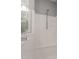 This bright shower features a white surround and a sleek showerhead with modern finishes at 23503 S 228Th Pl, Queen Creek, AZ 85142