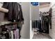 Organized walk-in closet with shelves, clothing racks, and storage, featuring a safe at 23503 S 228Th Pl, Queen Creek, AZ 85142