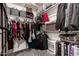 Organized walk-in closet with shelving, clothing racks, and ample storage space for clothes and accessories at 23503 S 228Th Pl, Queen Creek, AZ 85142