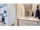 Hall bathroom featuring white cabinets, stone countertop, and a large mirror with modern decor at 24645 N 164Th Dr, Surprise, AZ 85387
