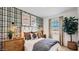Cozy bedroom with a plaid accent wall, rustic decor, and a comfortable bed with decorative pillows at 24645 N 164Th Dr, Surprise, AZ 85387
