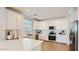 Bright kitchen featuring white cabinets, stainless steel appliances, and a large island with a white countertop at 24645 N 164Th Dr, Surprise, AZ 85387