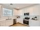 Modern kitchen with white cabinets, stainless steel appliances, and quartz countertops at 24645 N 164Th Dr, Surprise, AZ 85387