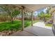 Backyard featuring a covered patio, lush lawn, mature trees, and privacy fencing at 2508 N Karen Dr, Chandler, AZ 85224