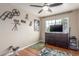 Cozy bedroom highlighting hardwood floors, decorative accents, and a ceiling fan for comfort at 2508 N Karen Dr, Chandler, AZ 85224