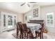 Cozy dining area with a large table, French doors, and a decorative fireplace creating a warm atmosphere at 2508 N Karen Dr, Chandler, AZ 85224