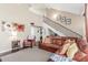 Bright living room with hardwood floors, high ceilings, and a comfortable leather sofa near the staircase at 2508 N Karen Dr, Chandler, AZ 85224