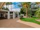 Lush backyard with a custom bar area, sparkling pool, and mature palm trees at 26 W Morten Ave, Phoenix, AZ 85021