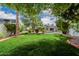 Private backyard with a manicured lawn, mature trees, and a relaxing pool area at 26 W Morten Ave, Phoenix, AZ 85021