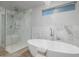 Luxurious bathroom featuring a freestanding tub and glass-enclosed shower at 26 W Morten Ave, Phoenix, AZ 85021