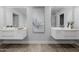 Bathroom featuring double sink vanity, framed mirrors, and modern fixtures at 26 W Morten Ave, Phoenix, AZ 85021