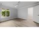 Bedroom featuring wood-look floors, modern ceiling fan, and backyard views at 26 W Morten Ave, Phoenix, AZ 85021