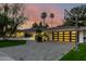 A stylish single-story home with a brick driveway, modern garage door, and basketball hoop at 26 W Morten Ave, Phoenix, AZ 85021
