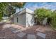 Exterior view of home showing neutral stucco, desert landscaping, and stepping stones at 26 W Morten Ave, Phoenix, AZ 85021