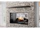 Close-up of a stone fireplace with a dark mantel, creating a warm and inviting focal point at 26 W Morten Ave, Phoenix, AZ 85021