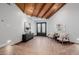 Inviting foyer with wood-look floors, beamed ceiling, and stylish decor at 26 W Morten Ave, Phoenix, AZ 85021