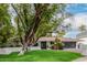 Single-story home boasts manicured landscaping, a modern garage door, and a spacious driveway at 26 W Morten Ave, Phoenix, AZ 85021