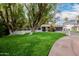 Single-story home boasts manicured landscaping, a modern garage door, and a spacious driveway at 26 W Morten Ave, Phoenix, AZ 85021
