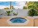 Inviting hot tub surrounded by lush greenery and desert landscaping at 26 W Morten Ave, Phoenix, AZ 85021