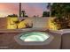 Backyard with hot tub surrounded by desert landscaping at 26 W Morten Ave, Phoenix, AZ 85021